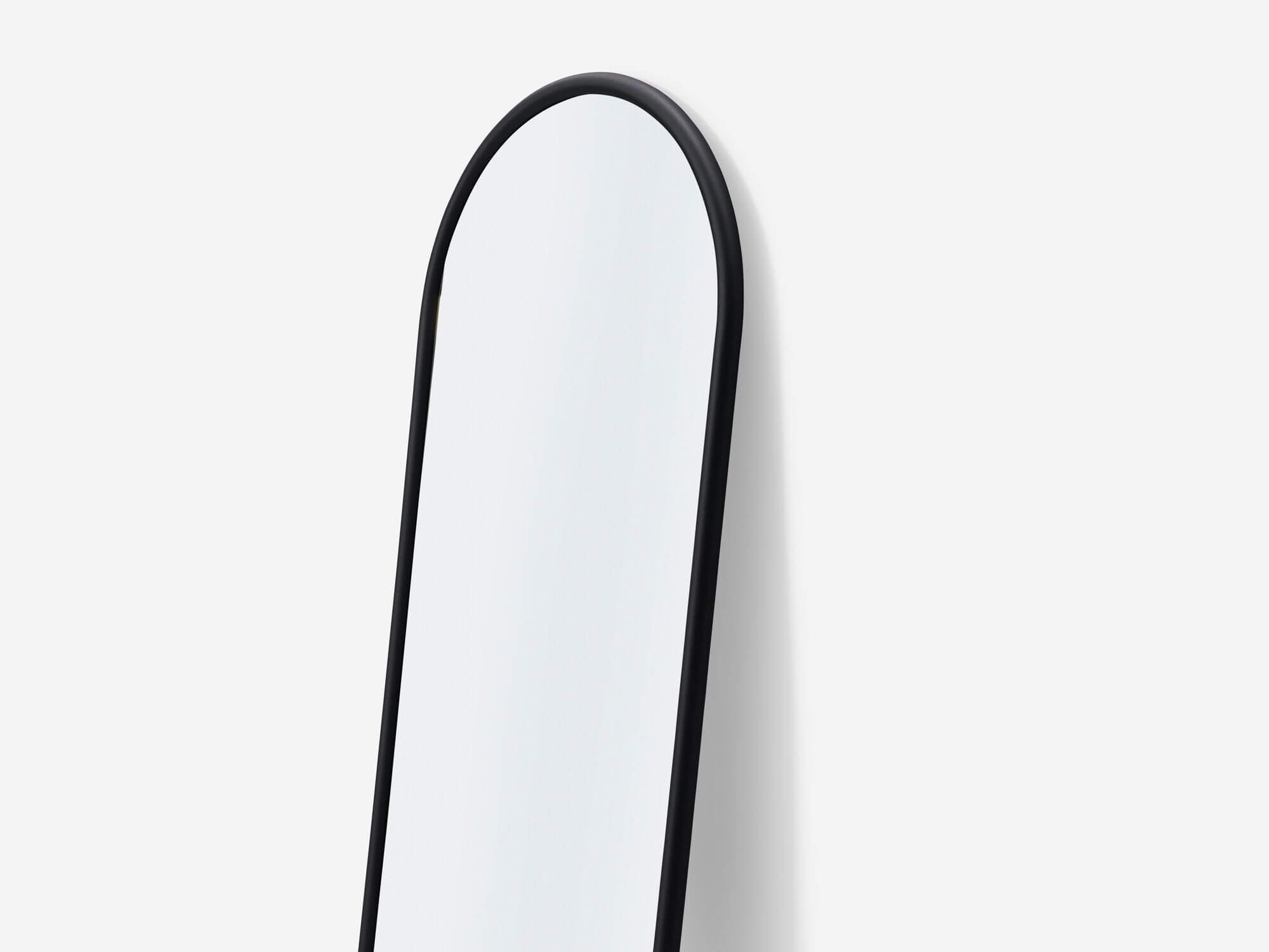 Full length mirror with black edge top detail view